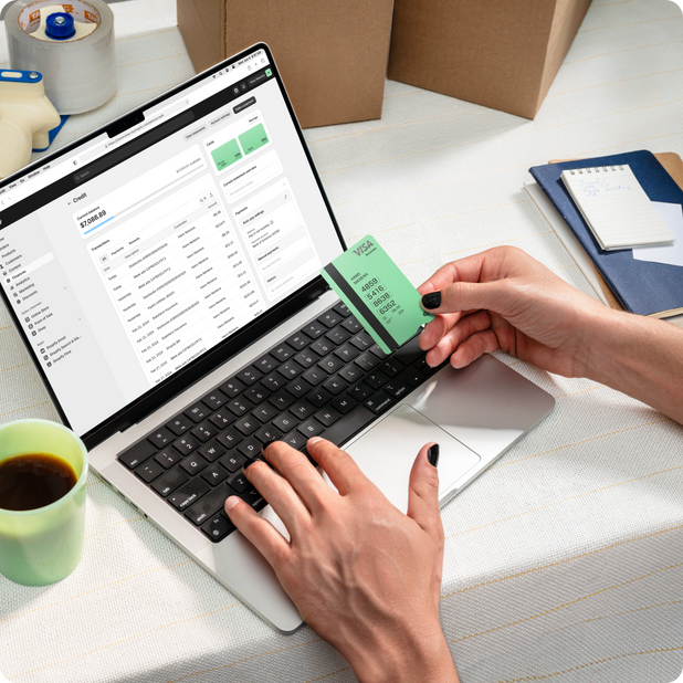 A Shopify Visa card sitting on top of a card pouch