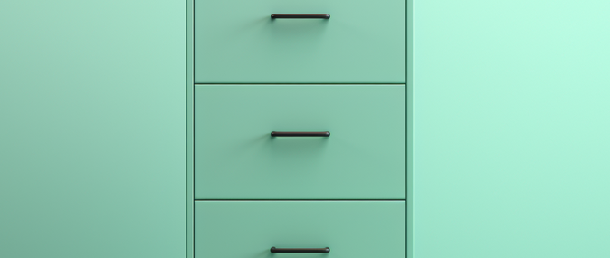 A green filing cabinet, symbolizing the successful filing of small business taxes.