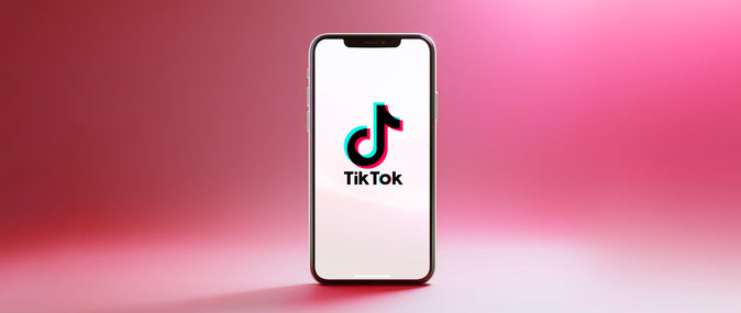 A mobile phone with a screen featuring a large TikTok logo