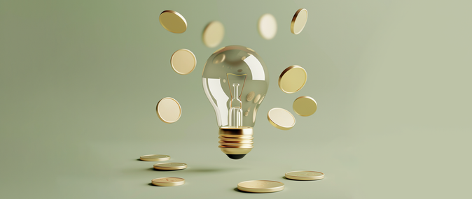 A light bulb is surrounded by falling coins, representing the concept of a million-dollar business idea.