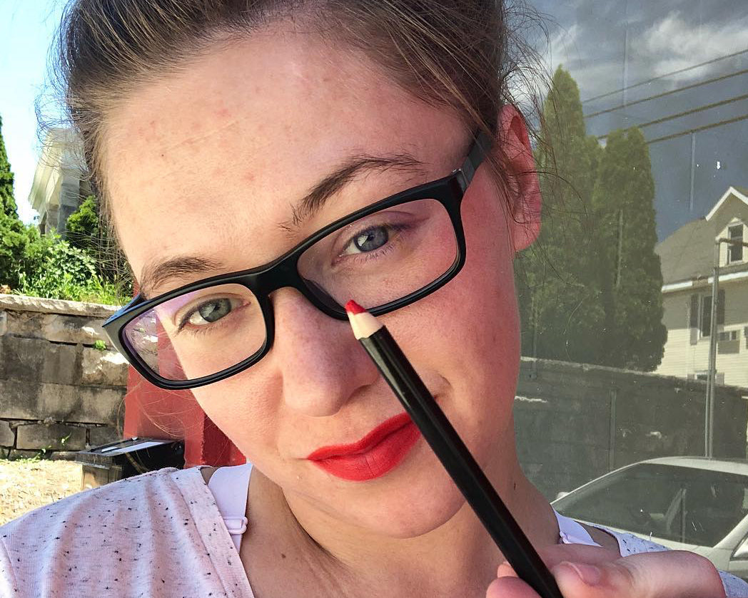 Beauty founder Megan Cox holds a lip liner