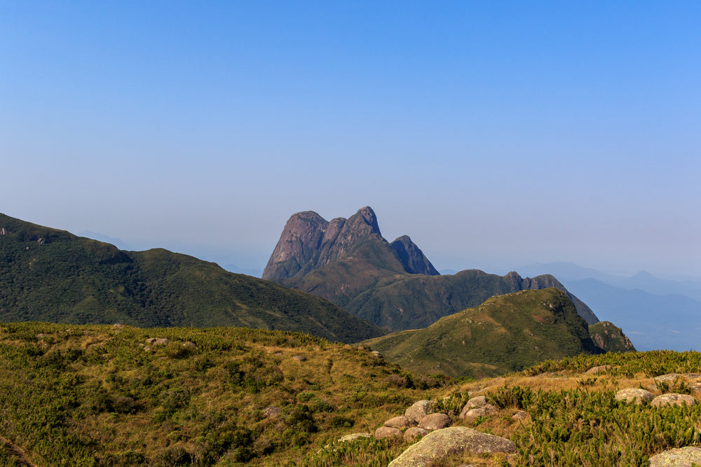 landscape of green rolling hills and mountain peaks