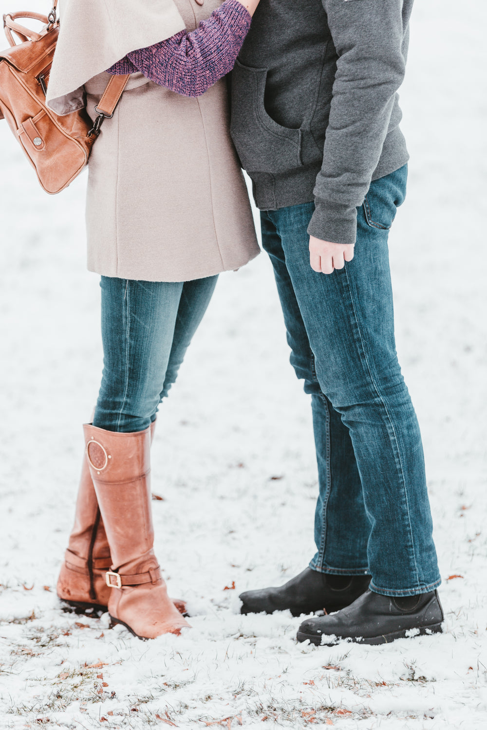 a couple steals a warm embrace in winter