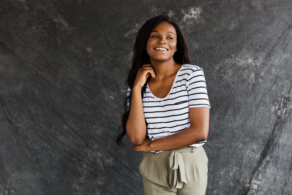 a model in summer fashion with grey backdrop