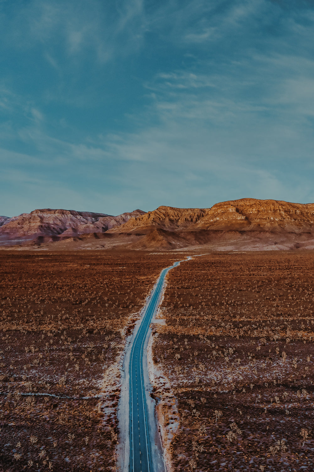 aerial photo of paved road through the desert