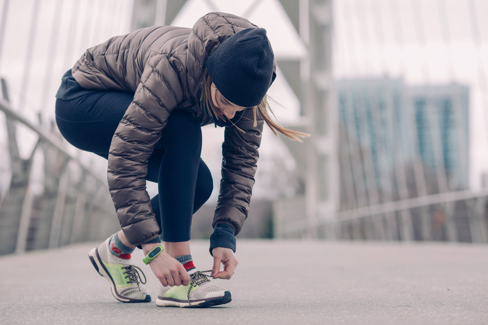 athlete tying running shoes