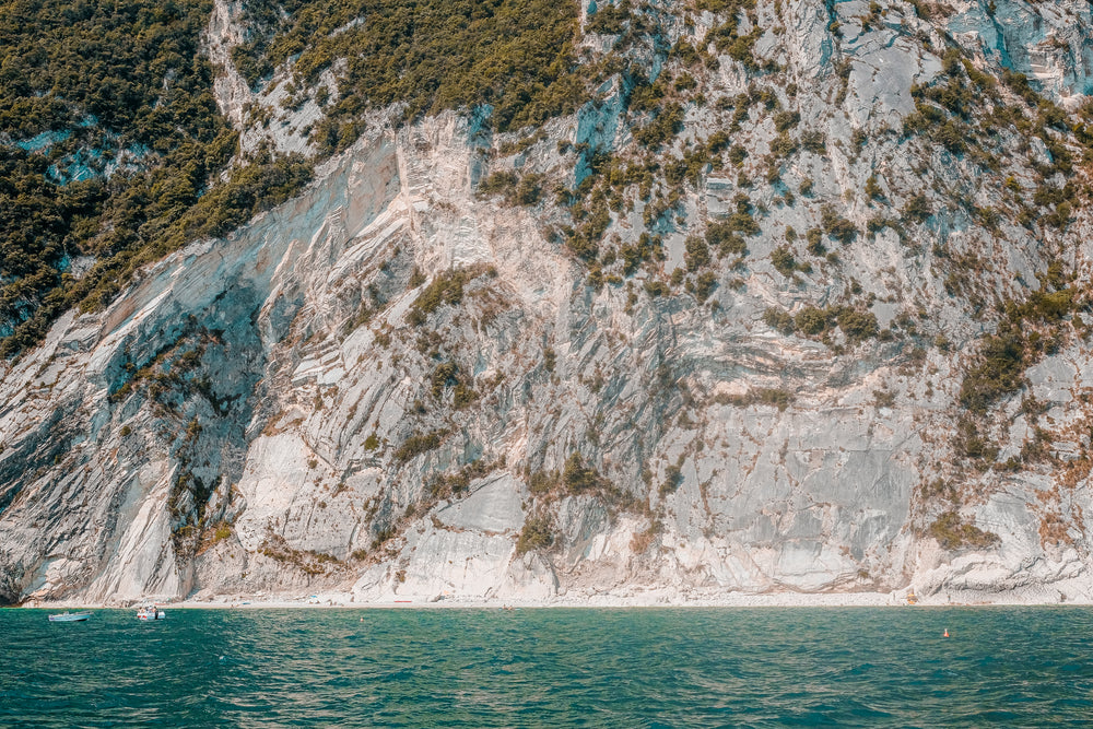 blue water and white cliffs surrounded by trees