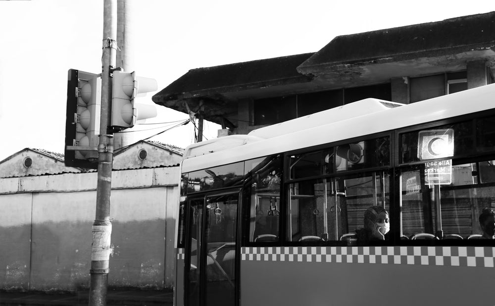 bus at a light with a person in their phone