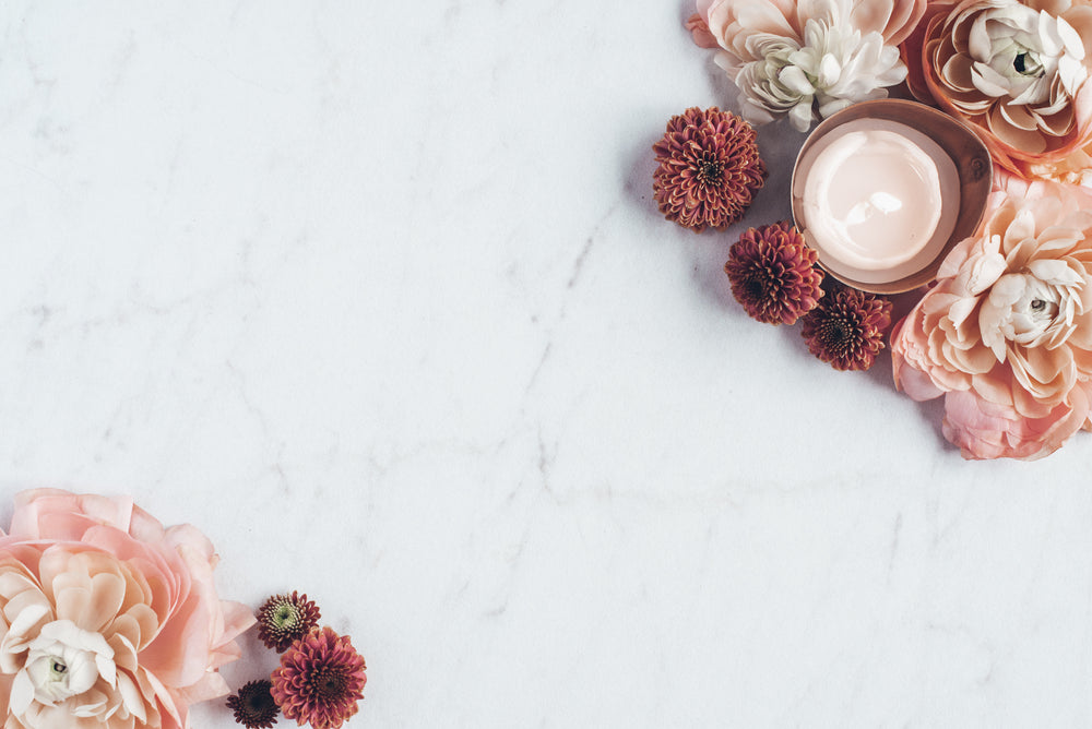 candle nestled among flowers