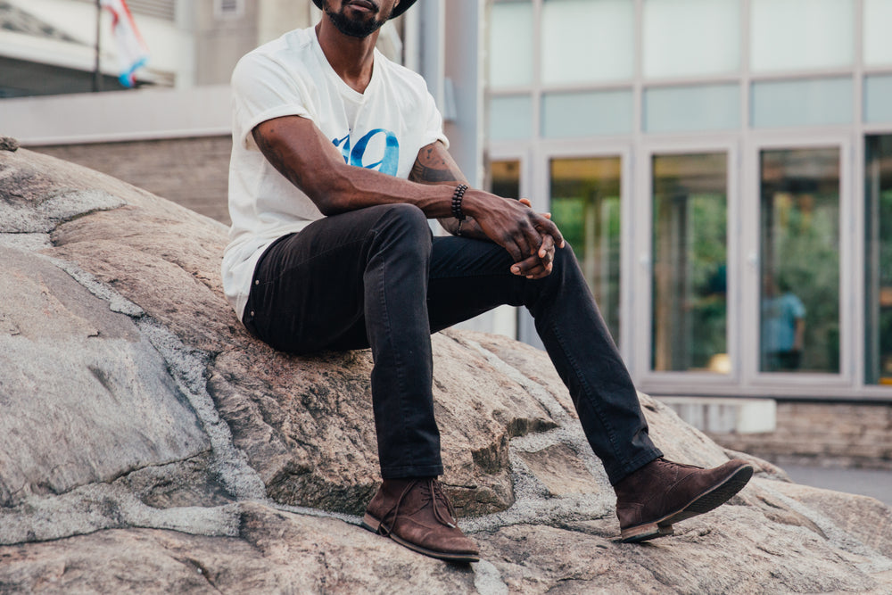 casual man sits on rock