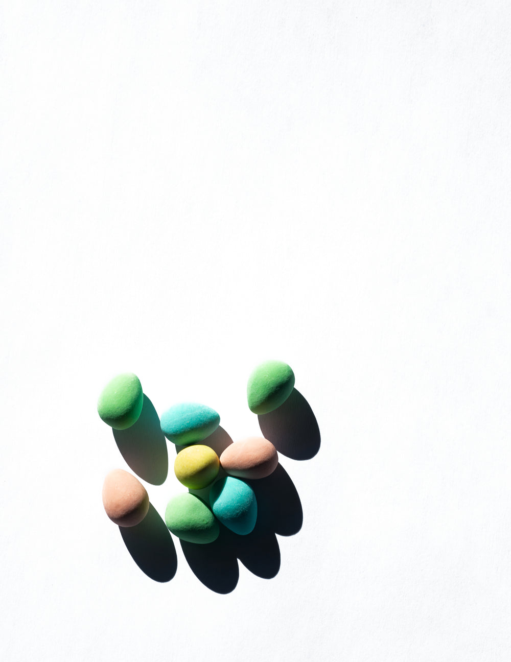 colorful candy eggs against a white background