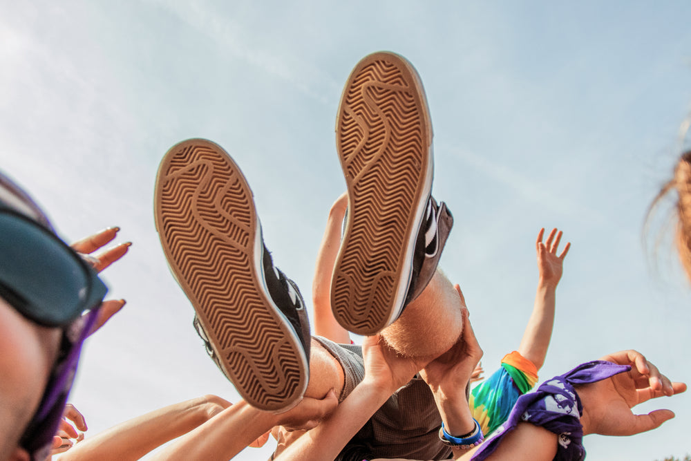 crowd surfers feet