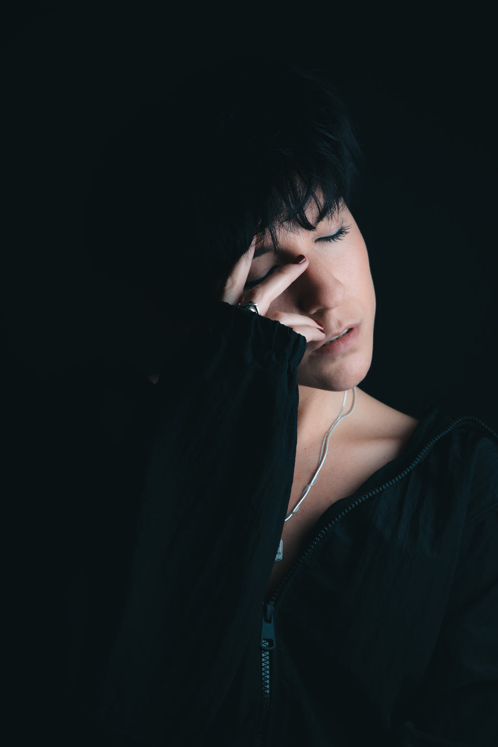 dark portrait of woman with her eyes closed