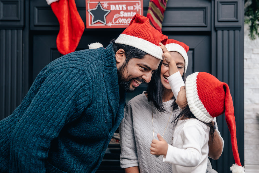 family trying on santa hats