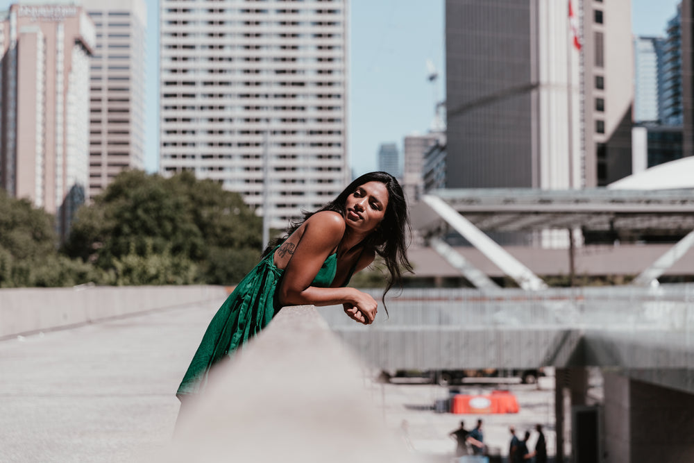 fashionable woman with city buildings behind