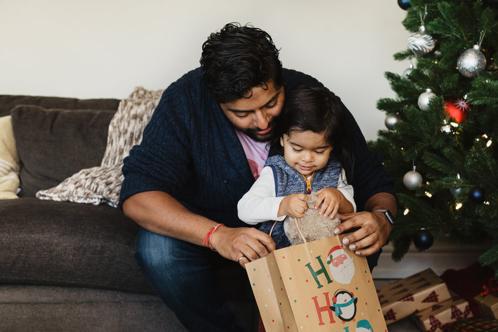 father and son open christmas gifts