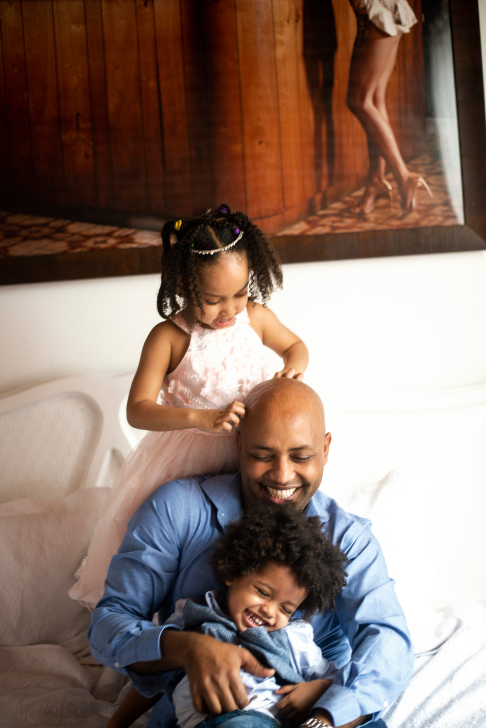 father laughing with his kids