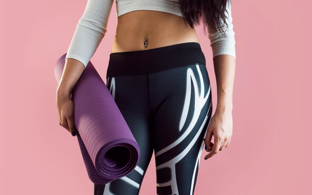 female yoga fashion with yoga mat