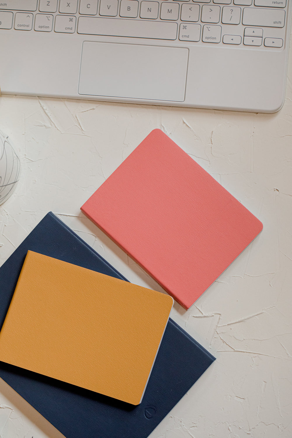 flatlay of notebooks and a laptop keyboard