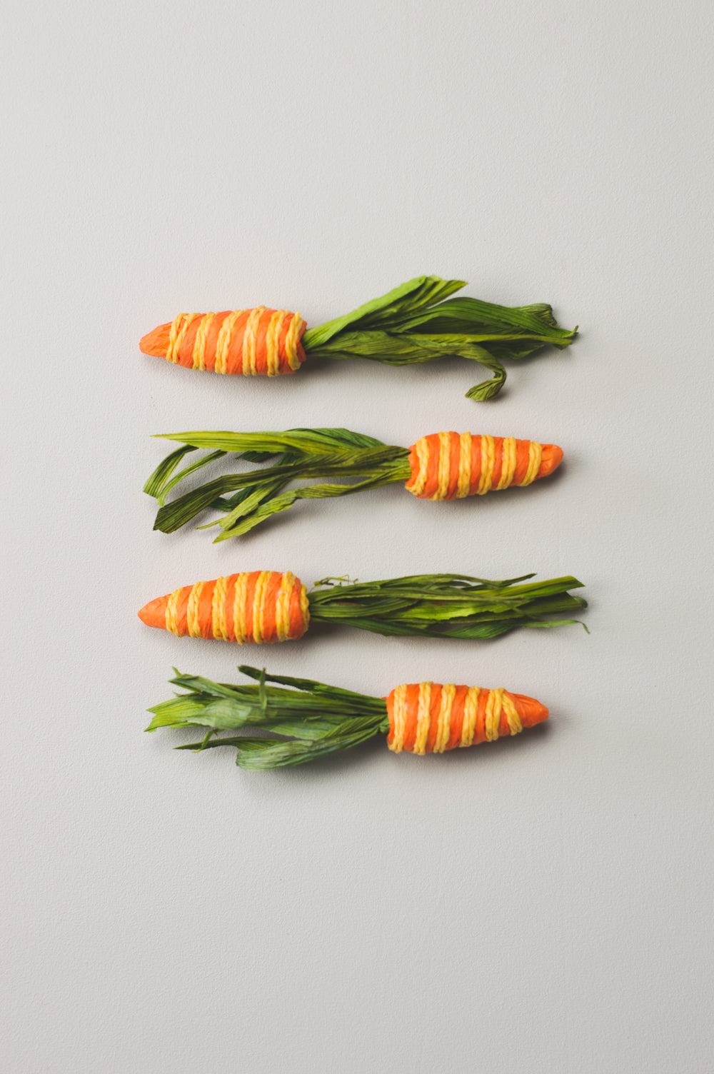 four paper crafted carrots