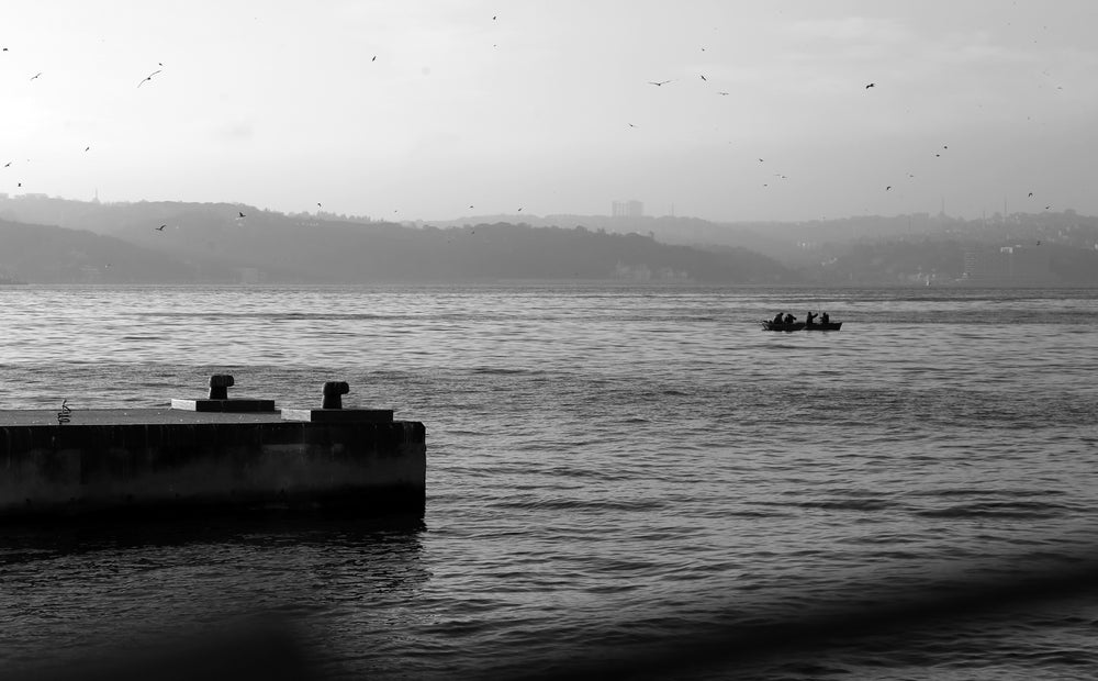 four people on a boat in the water