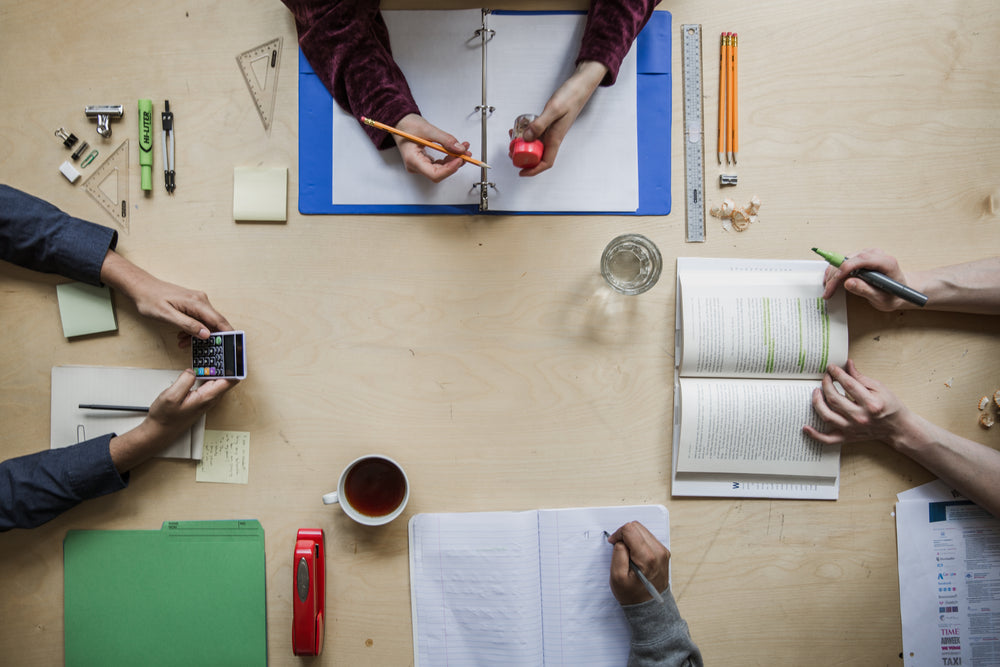 four students study flatlay