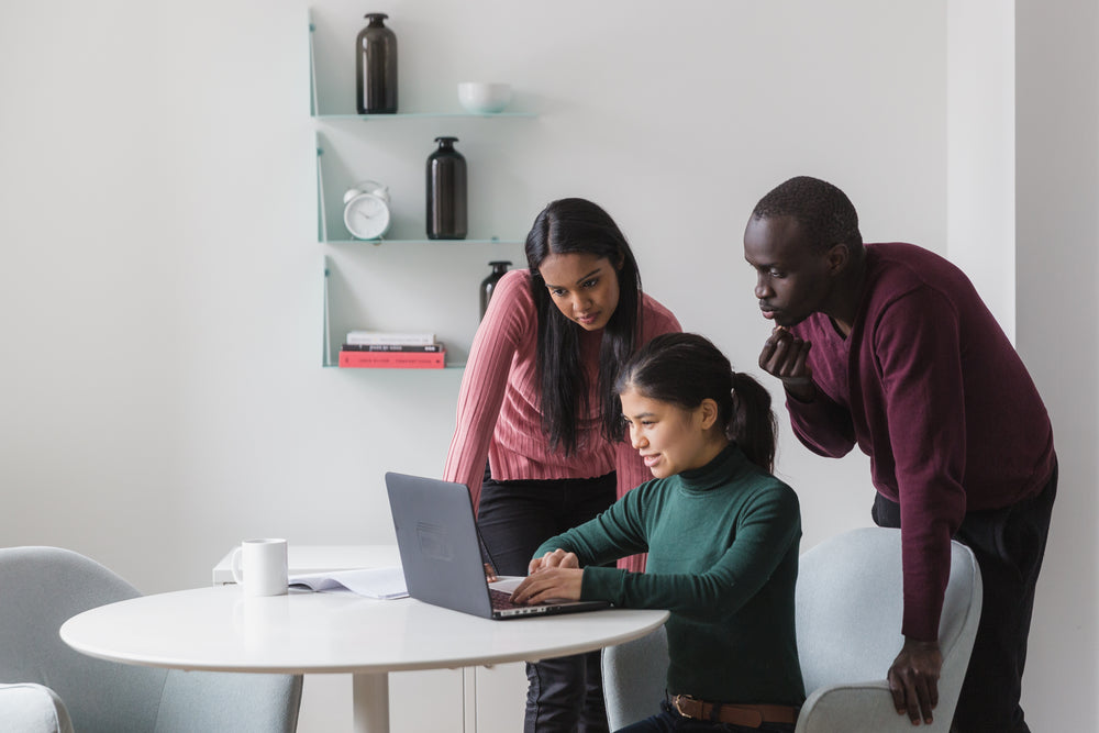 friends look on laptop in office