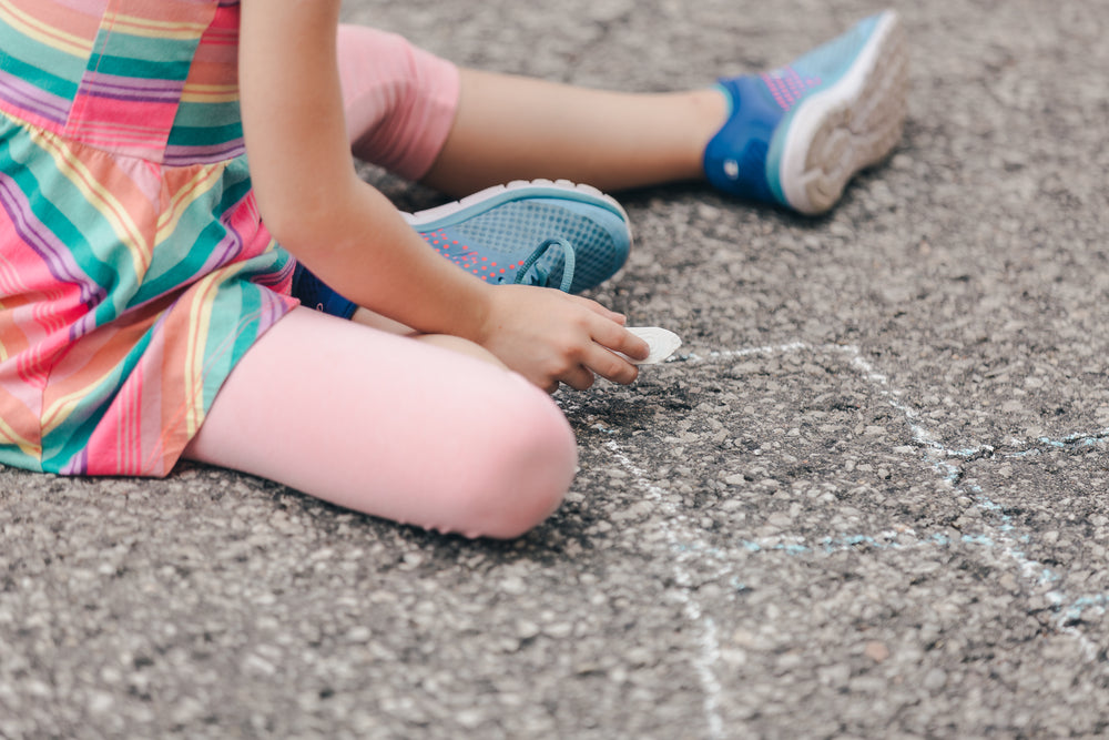 girl holding sidewalk chalk