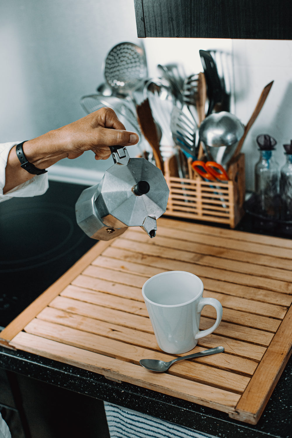 hand about to pour stove top coffee