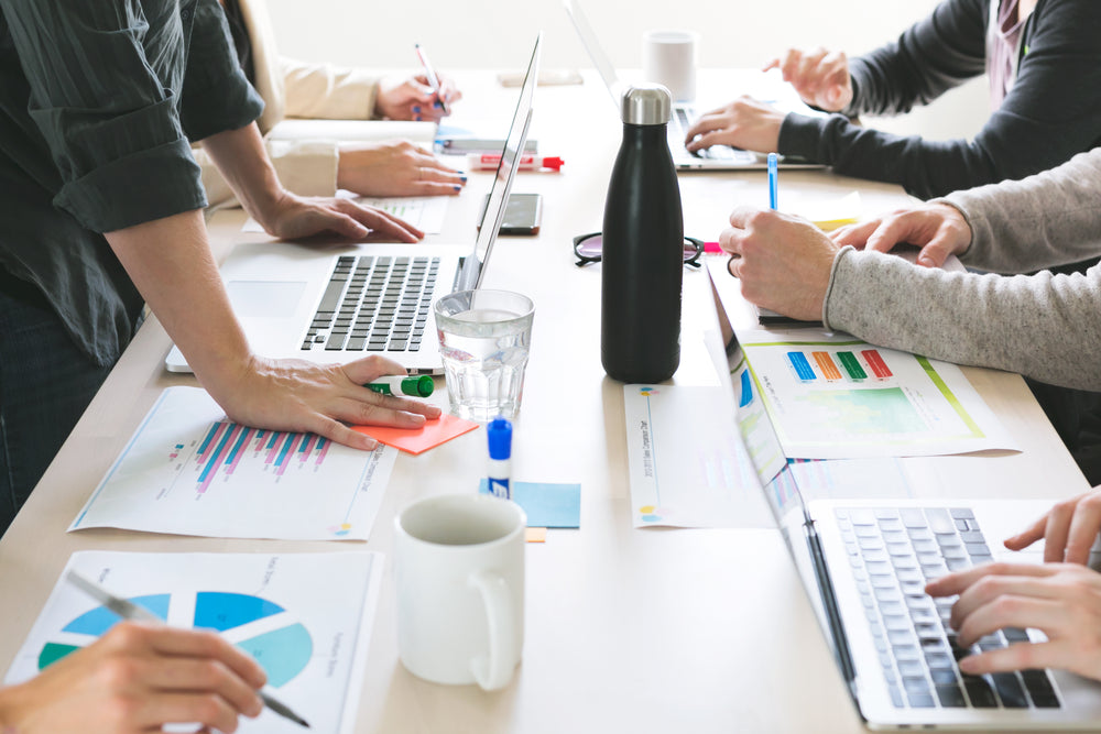 hands on desk at meeting