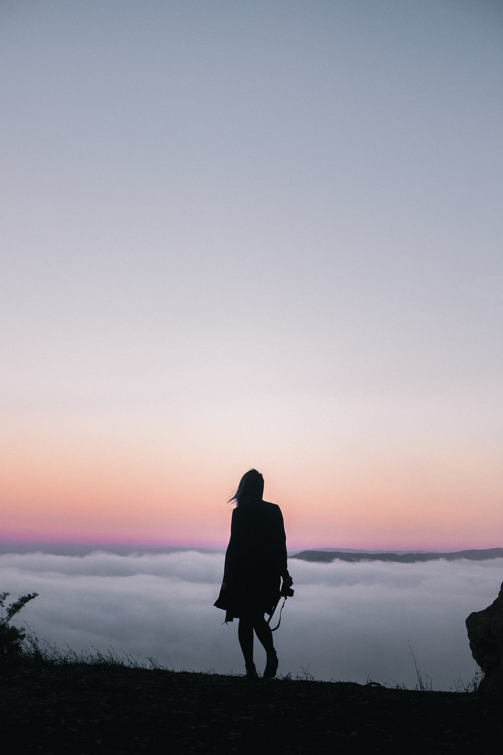 hiking above clouds at sunset