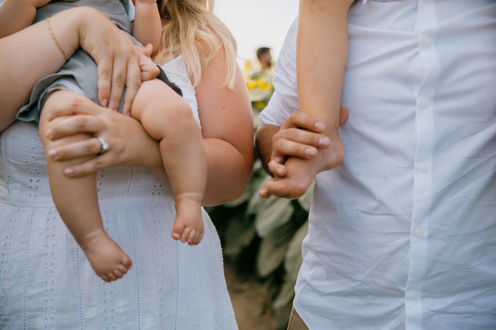 kids feet held by adults