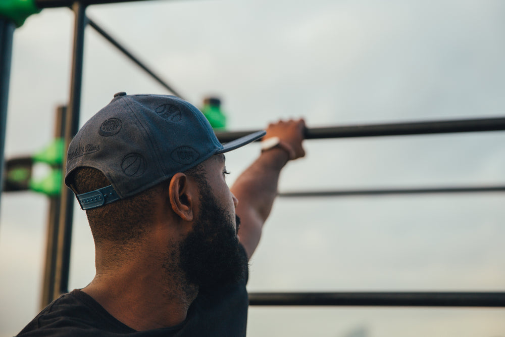 man reaching for bar