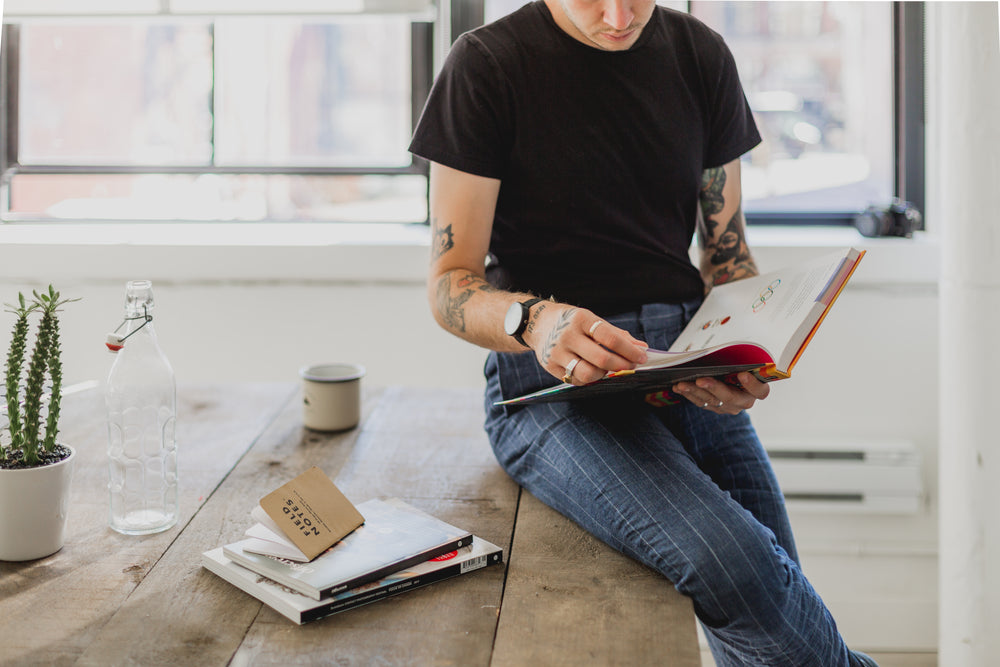 man reads book in studio