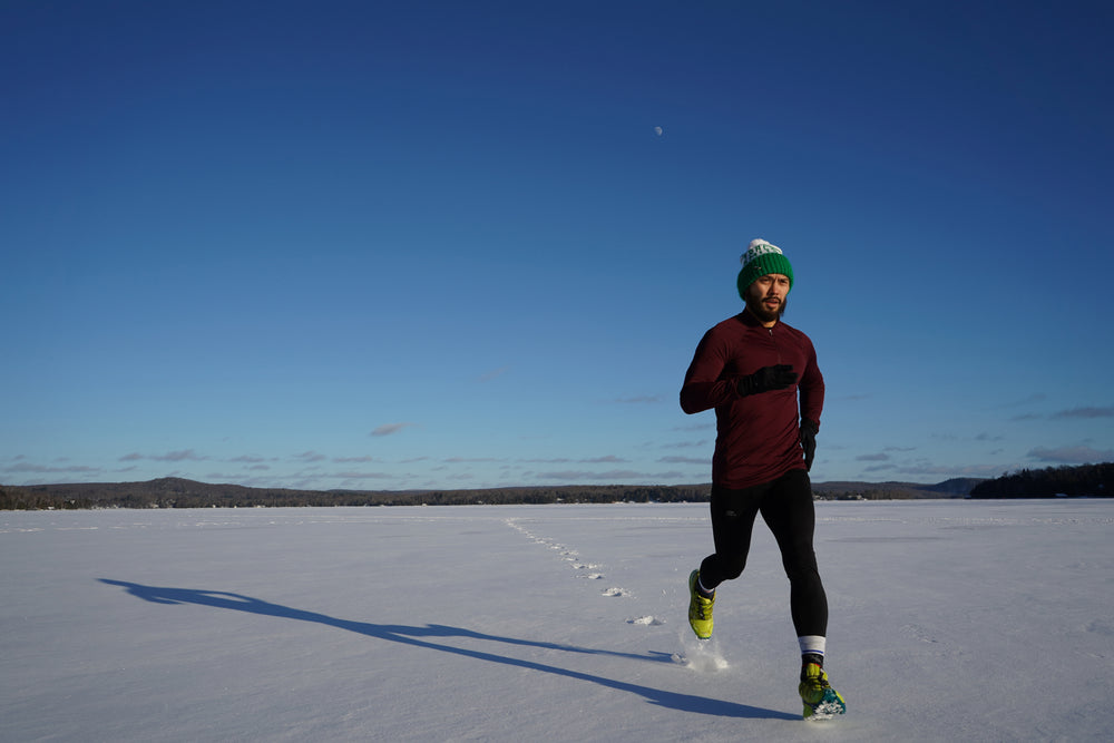 man runs across snow