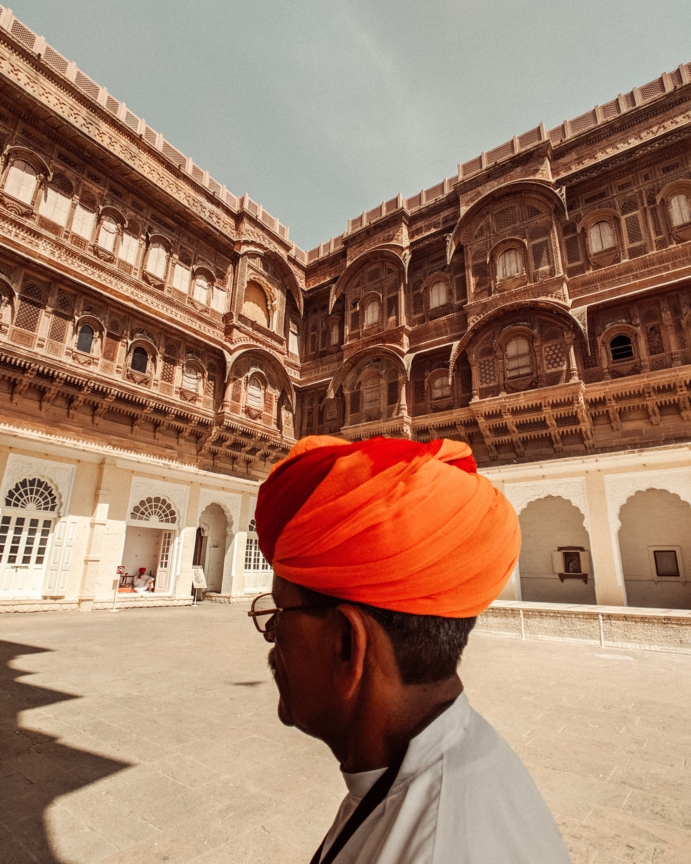 man walks through courtyard