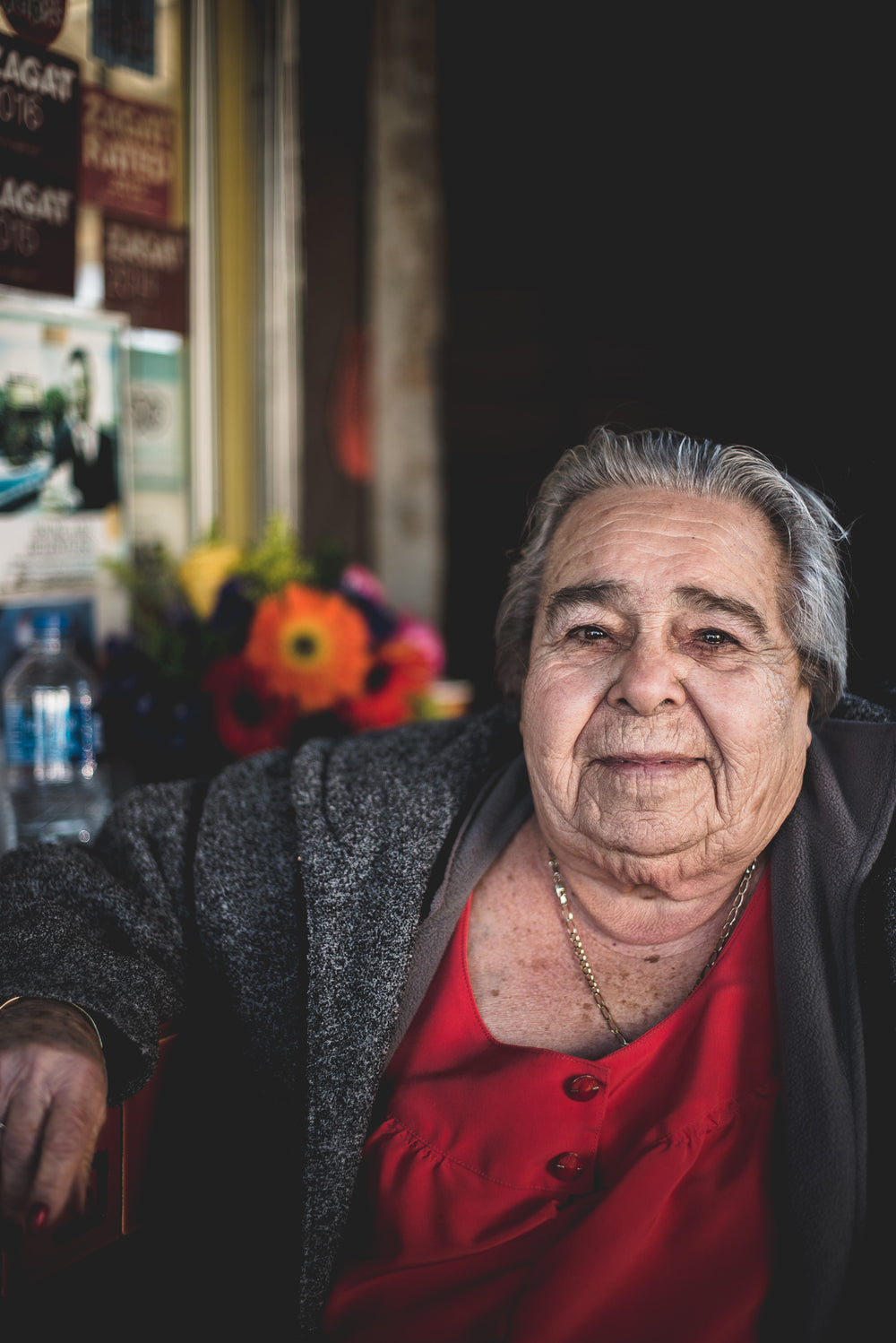 mature woman sitting outside of restaurant