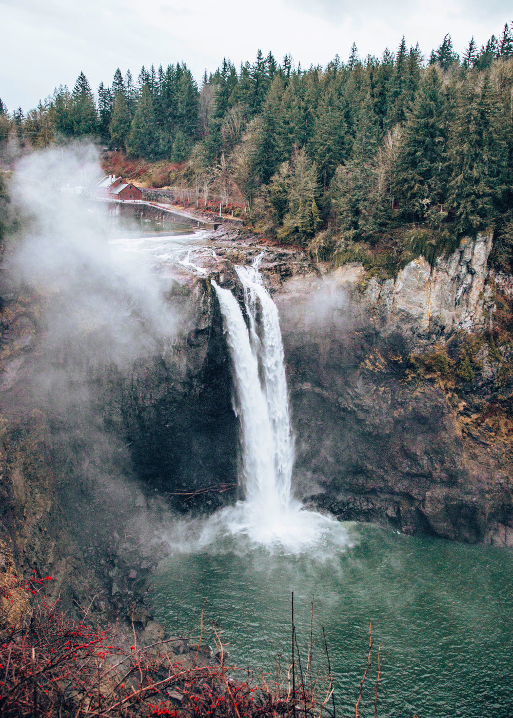 mist rises above rocky water fall