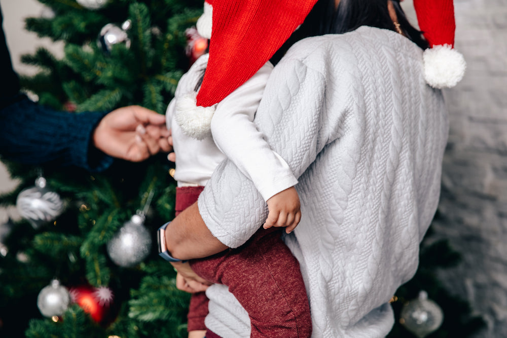 mother and son check out the christmas tree