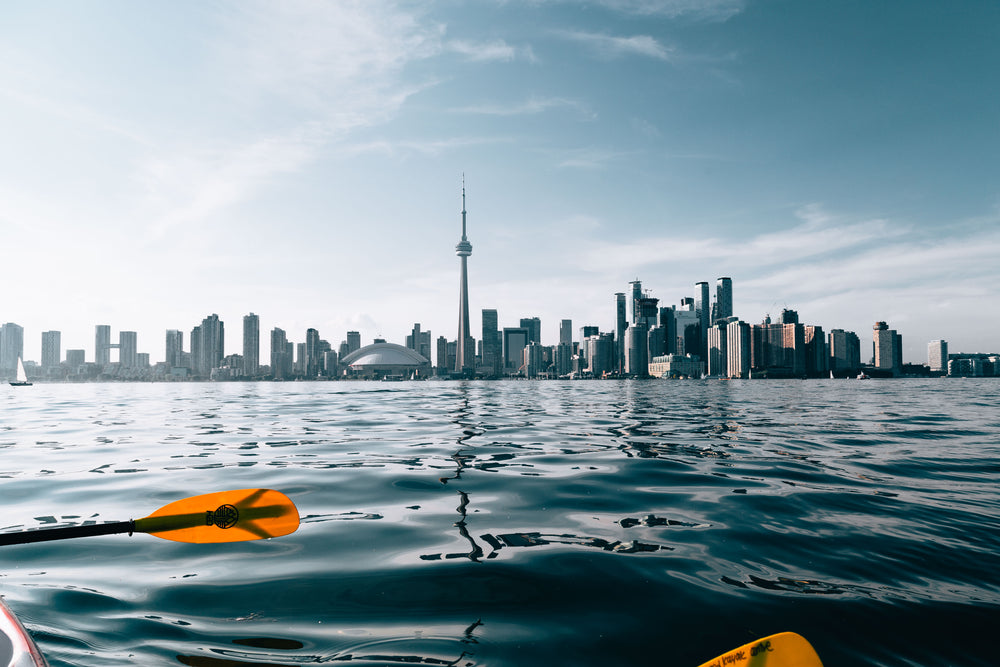 paddling by city skyline