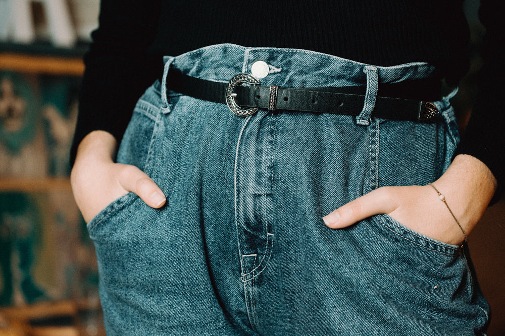 person holding their hands in jean pockets