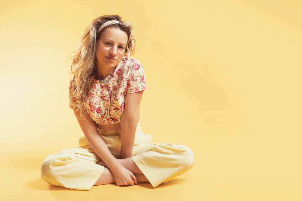 person sits cross-legged in summer fashion