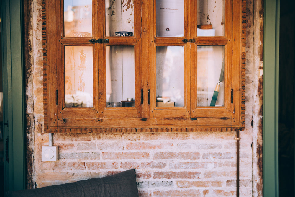 rustic wooden window frame against exposed brick