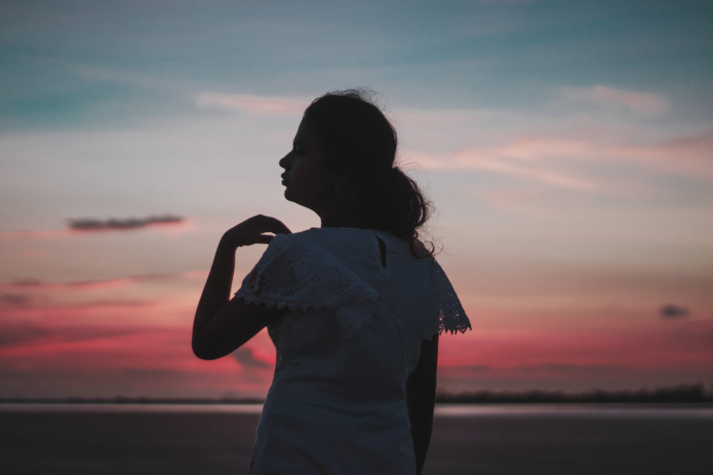 silhouette of a persons profile at sunset