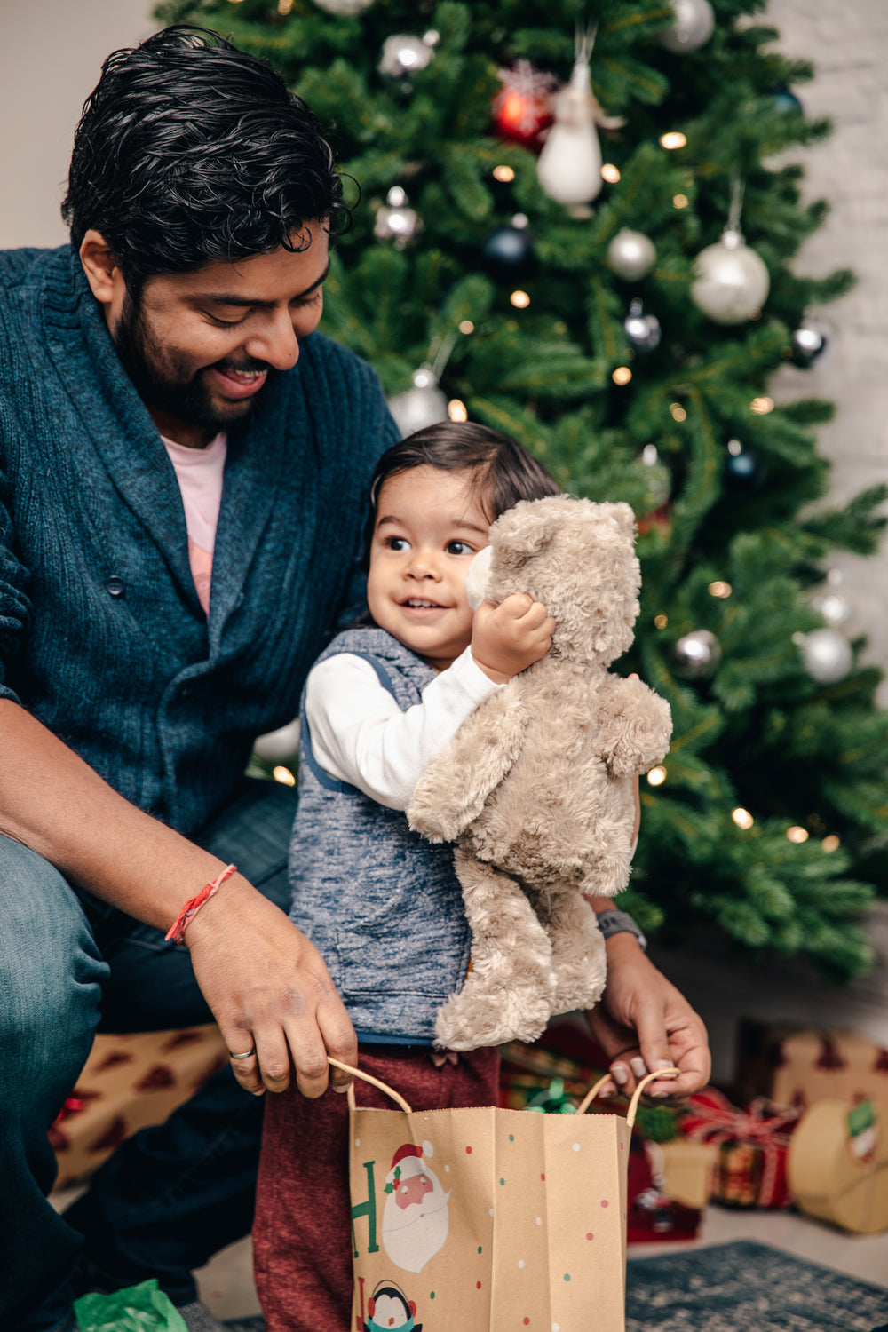 small boy gets teddy bear for christmas