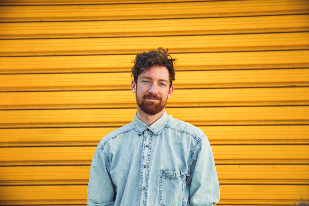 smiling man and yellow door