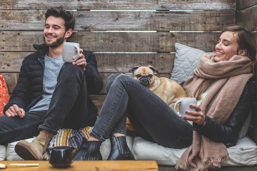 smiling man woman pug