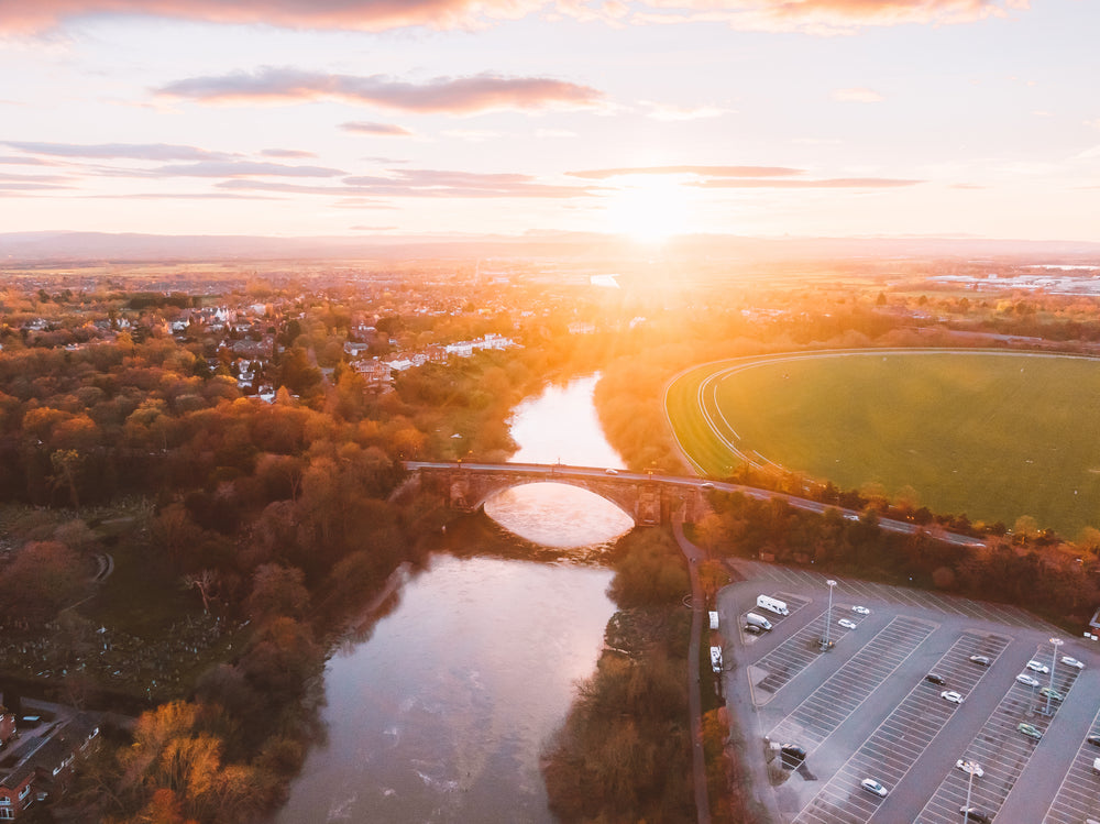 sunset over a river paints the stony bridge gold