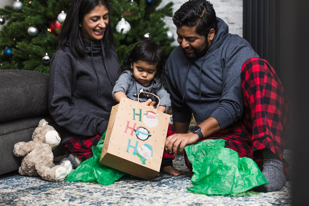 toddler opening gifts on christmas morning