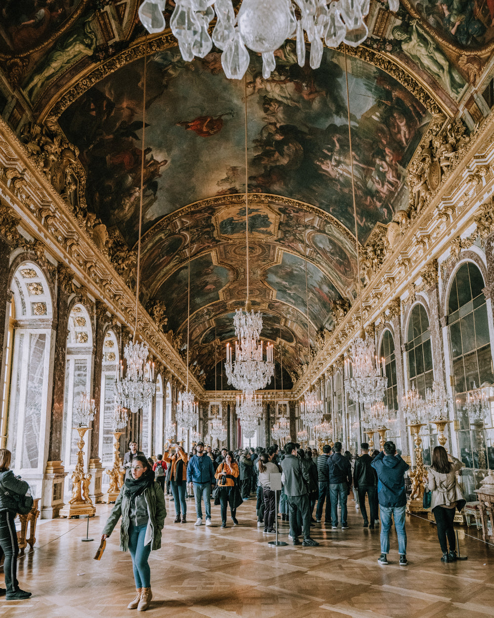 tourists beneath fresces at versailles